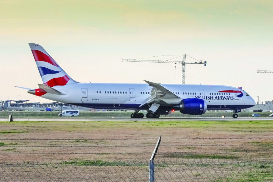 British Airways first flight landing in Austin in 2014 with the cockpit crew waving an American flag in celebration of the new route connecting Austin and London Heathrow. The airline began flying to Austin with the Boeing 787 and now services the route with a 747-400 during the summer and 777-300ER during the winter season. photo by Mateen Kontoravdis