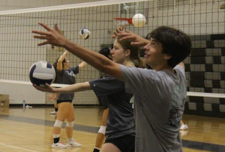 SERVE IT UP: Robby Cole learns how to serve with the rest of the volleyball team. The raptor Rundown allows a member of the Liberator to learn a new sport. photo by JC Ramirez Delgadillo