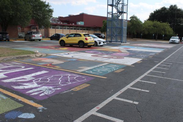 A row of colorfully painted senior parking spots, created over the summer by the class of 2024.