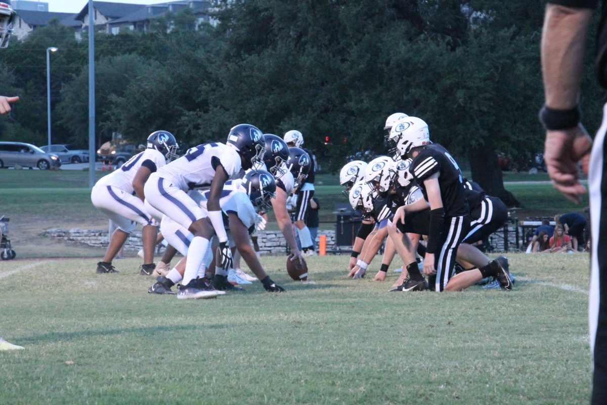 The two teams face off at the line of scrimmage split seconds before the play starts. During this moment of tension, players must be careful not to jump too early.