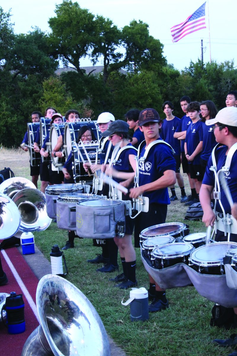 TIME FOR TEMPO | The LASA Raptor Band drumline performs on the sidelines of the field to energize the student section.