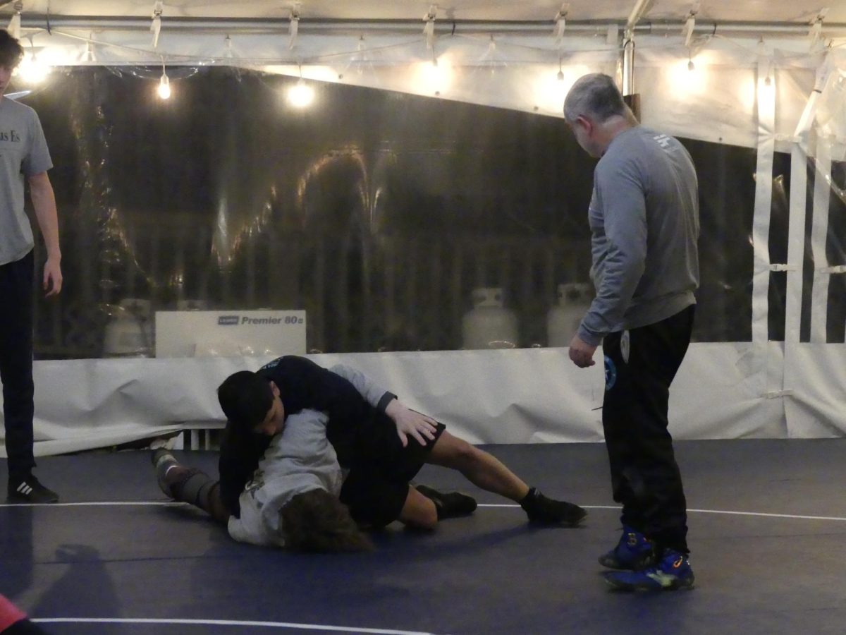 GROWING GREATNESS Wrestling club members practice technique. The club trains in a large tent outside the fields
at 6 a.m. 